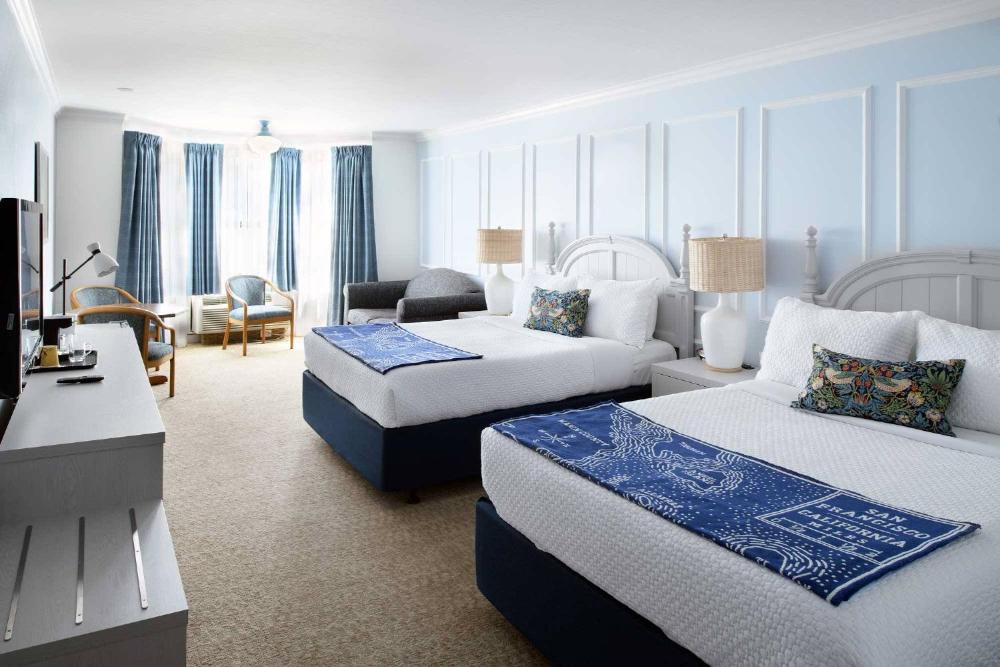 Two Queen Beds With A Couch interior